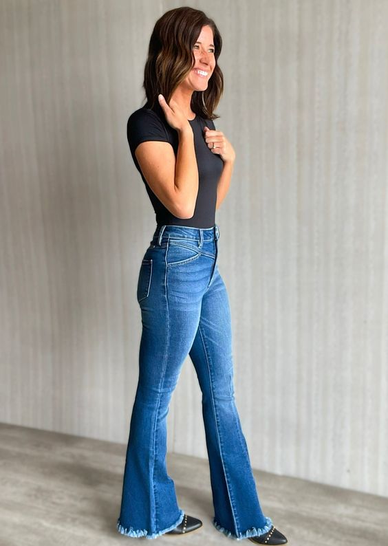 dark blue flared jeans and black studded boots